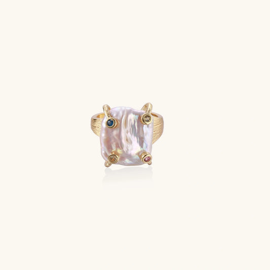 Gold ring with large iridescent baroque pearl and four colored gemstones on textured band