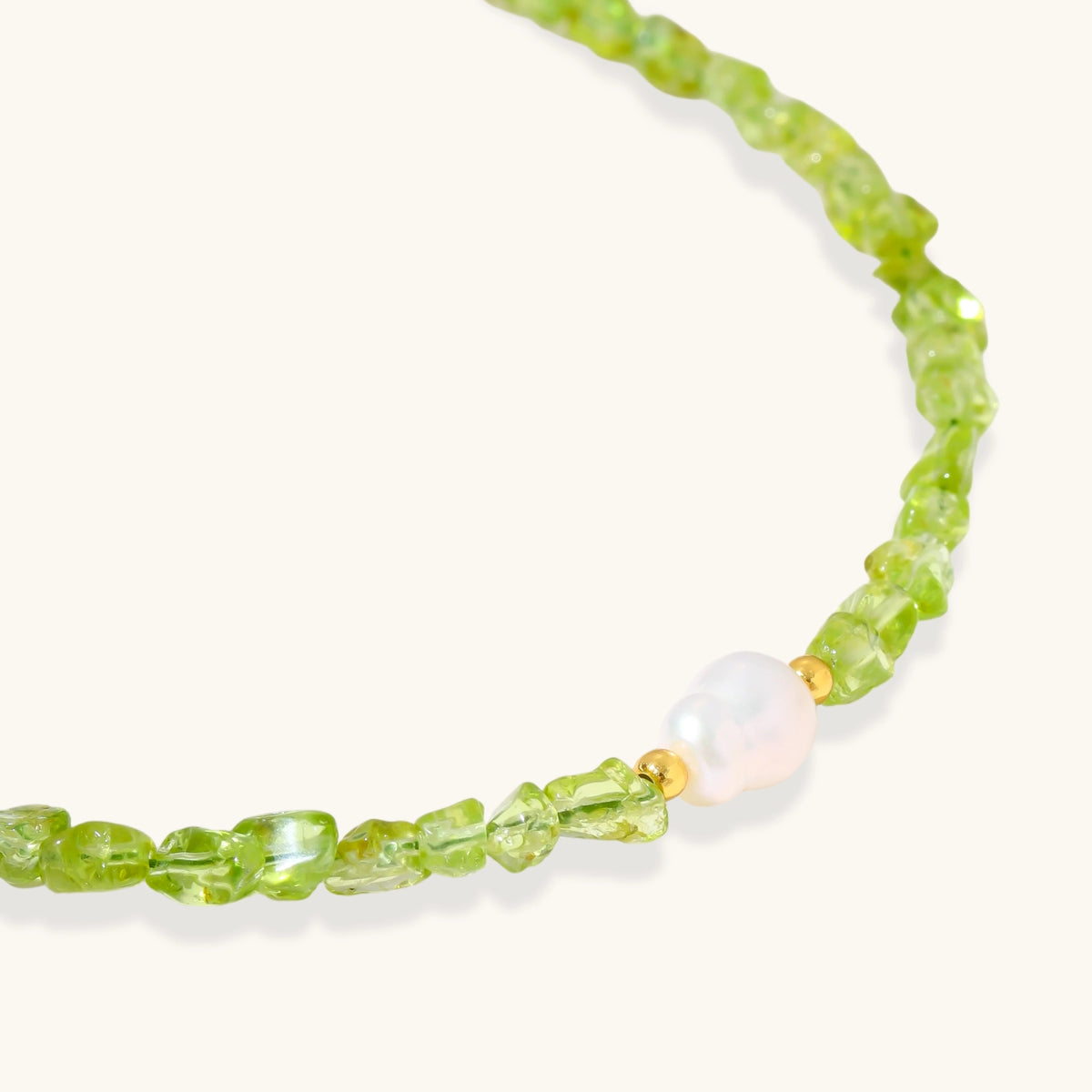 Delicate sterling silver bracelet with lime-green peridot gemstone chips and single freshwater pearl centerpiece